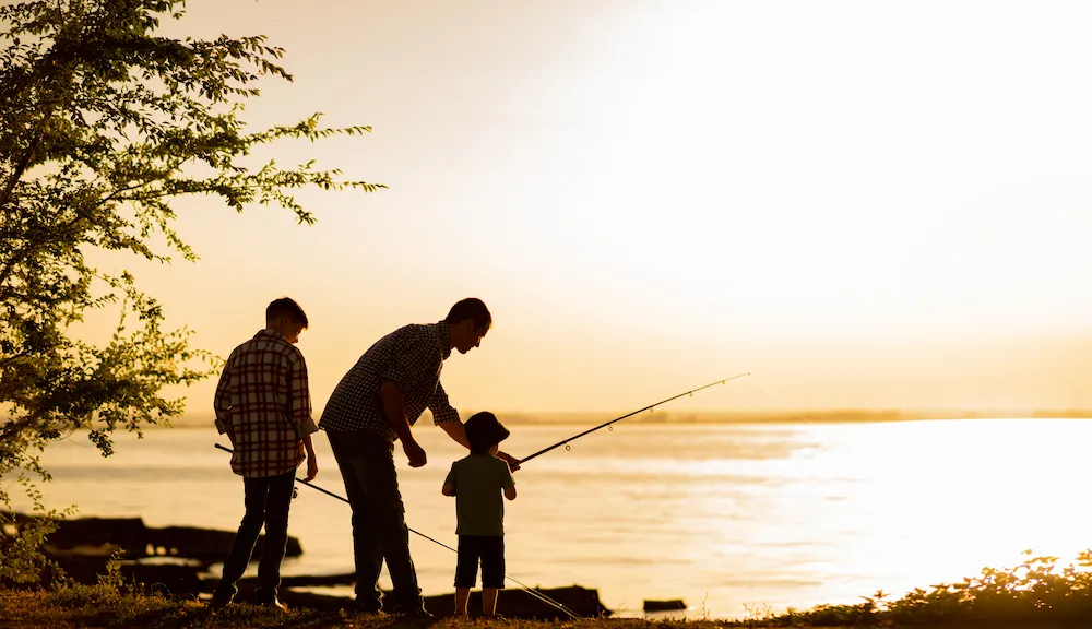 Father and two sons fishing together