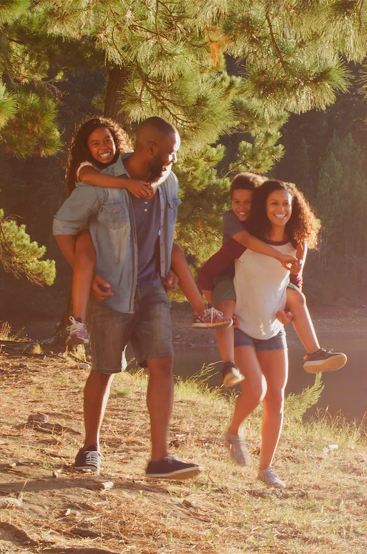 Family Hiking By a Lake in the Woods